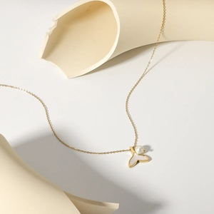 Elegant mermaid tail necklace with natural pearl pendant on a minimalist background