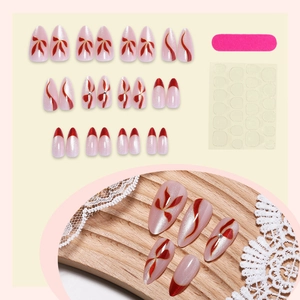 Pink pearl base press-on nails with red hand-painted bows and silver accents set