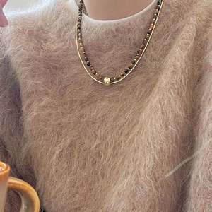 Retro layered brown tiger eye bead necklace with a gold bead pendant on a fine chain
