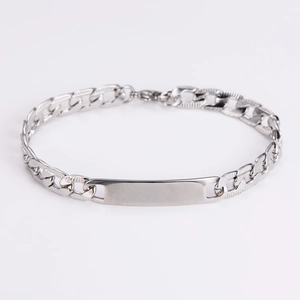 Close-up of silver Cuban link chain bracelet with a polished blank rectangular ID plate