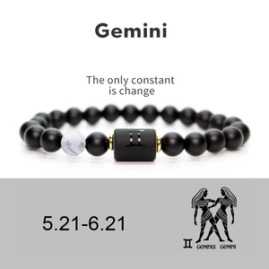 Detail of Gemini beaded bracelet with matte black agate stones and zodiac symbol plate