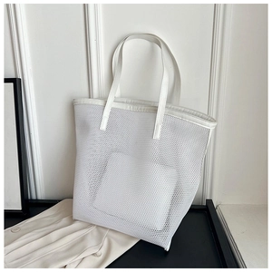 Macro side view of white mesh tote bag showing breathable hollow PVC material and handles