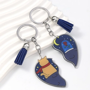 Detail of acrylic heart-shaped keychains with cat, rose patterns and blue leather tassels