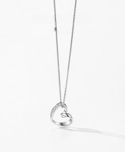 Macro detail of S925 silver hollow heart pendant with micro-inlaid zirconia stones