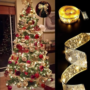Detail of golden LED Christmas ribbon with star patterns and battery box for Xmas tree decor