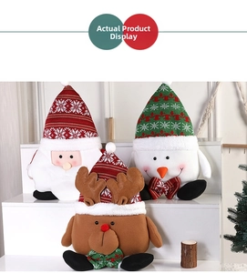 Detailed close-up of plush Christmas Santa, Reindeer, and Snowman dolls on display
