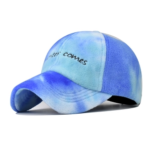 Detailed close-up of 'winter comes' embroidery on soft tie-dye fleece baseball cap
