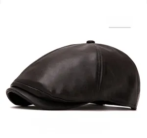 Detail shot of brown leather newsboy cap showing textured surface and fine stitching