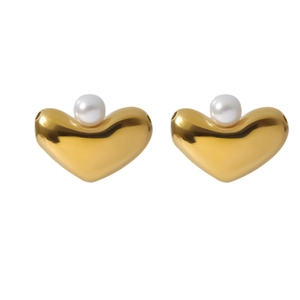 Golden heart-shaped earrings with white pearl detail on a clean white background