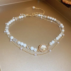 Elegant double-layered necklace featuring faux pearls, crystals and a faceted gemstone pendant