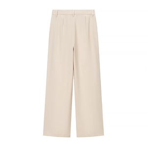 Detail view of beige wide-leg trousers in premium suit fabric with minimalist design