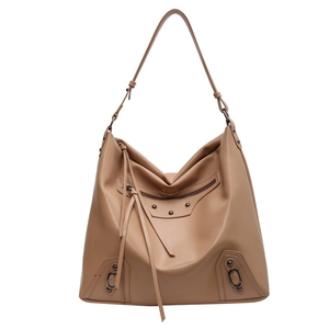 Large khaki tote bag with vintage rivets and long tassels in stylish motorcycle style