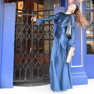 Elegant deep blue long-sleeve satin evening dress with backless detail and high side slit