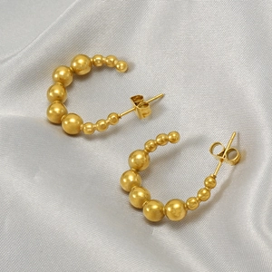 Chic 18k gold plated stainless steel bead hoop earrings displayed on grey silk fabric