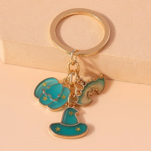 Detail of Halloween keychain with teal enamel pumpkin, bat, and witch hat charms