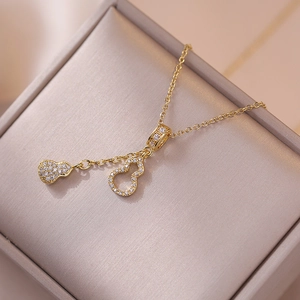 Elegant gold gourd necklace with micro-paved zirconia pendant in a luxury jewelry gift box