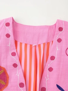 Detailed macro view of pink cotton linen jacket collar with delicate floral embroidery