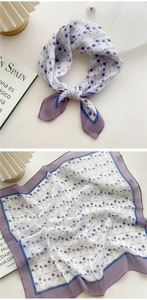Detail of purple floral square scarf with delicate rolled edges in light chiffon material