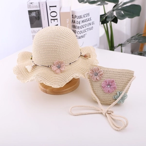 Detail of straw hat and matching bag with mesh floral decorations and shiny crystals