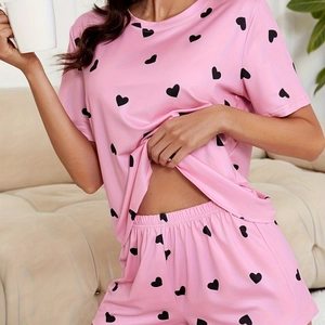 Pink heart print pajama set featuring short sleeves and elastic waist shorts for women