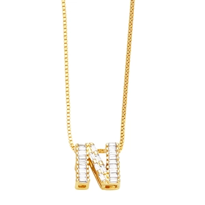 Detail of gold box chain and letter N pendant set with sparkling rectangular zircon