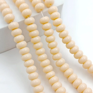 Close-up of 8x5mm cream-colored glass abacus beads for DIY jewelry making