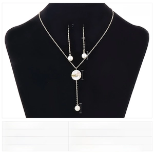 Detail of gold-tone necklace and earrings set featuring shell inlays and LOVE lettering