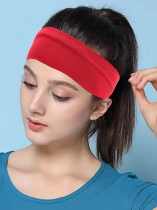 Close-up of bright red high-elastic sports headband with sweat-wicking knit texture