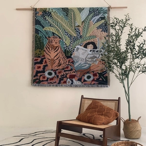 Bohemian woven outdoor picnic blanket featuring woman reading and tiger illustration