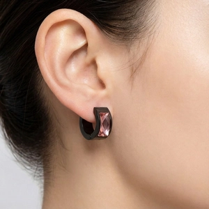 Close-up of black stainless steel hoop earring with a rectangular pink zircon stone