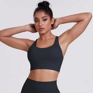 Detail of black high-waisted yoga leggings and high-impact sports bra on a model