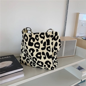 Detailed texture of high-capacity canvas tote bag with stylish leopard animal print