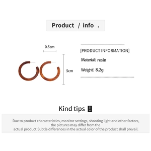 Macro detail showing dimensions of brown resin C-shaped hoop earrings for women