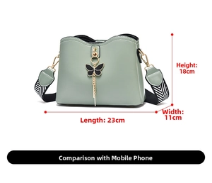 Detail view of sage green shoulder bag with patterned strap and size dimensions