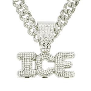 Macro detail of silver hip hop Cuban chain with sparkling iced-out ICE letter pendant