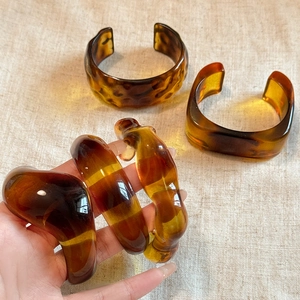 Retro geometric amber acrylic bangle with irregular textures and translucent finish