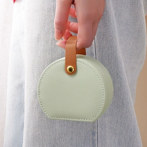 Portable mint green mini jewelry storage box with brown leather handle and gold buckle