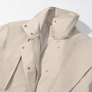 Close-up of beige motorcycle jacket lapel with metallic buttons and zipper detail