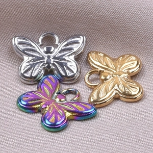 Macro detail of butterfly charms in silver, gold and rainbow 18k plated stainless steel