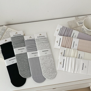 Breathable cotton crew socks with ribbed texture in multiple colors and minimalist packaging