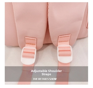 Detail of adjustable pink shoulder straps with white plastic buckles for kids backpack