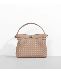 Close-up of the intricate leather weaving texture and silver metal twist lock detail