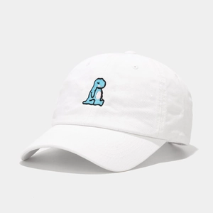 Close-up of a white cotton baseball cap featuring detailed blue dinosaur embroidery on front