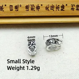 Detailed view of silver ethnic charm with engraved patterns and heart cutout, 13mm size