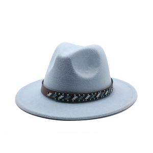 Detail of light blue fedora hat featuring a brown leather ethnic patterned decorative band