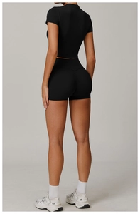 Rear view of slimming black brushed yoga set featuring tight crop top and high waist shorts