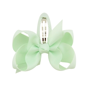 Detail view of mint green grosgrain ribbon bow hair clip with silver metal snap base