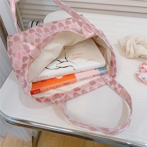 Top view of pink heart jacquard tote bag interior showing spacious storage for books