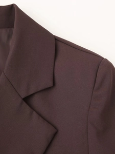 Close-up of lapel and shoulder stitching on a dark brown slim-fit cropped blazer
