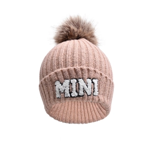 Detailed pink knit beanie featuring MINI embroidery and fluffy brown faux fur pompom